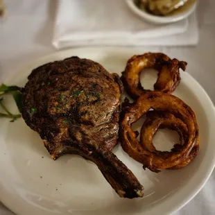Bone in ribeye with complementary onion rings