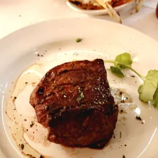 a steak on a white plate