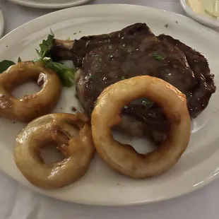 Bone in Ribeye with onion rings.