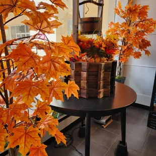 a basket of fall leaves on a table