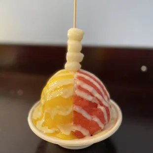 Shaved ice with mango and strawberry purée. Mochi and condense milk topping.