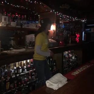 a woman standing at the bar