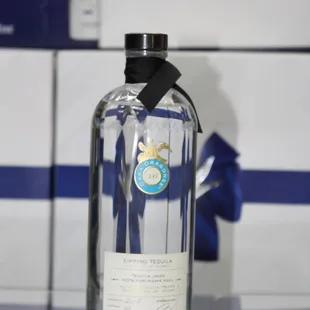 a glass bottle with a black ribbon