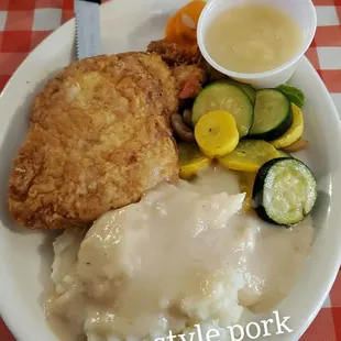 Country style pork chops with mash potatoes and veggies with apple sauce