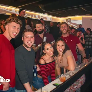 a group of people at a bar