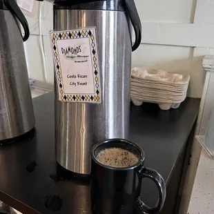 a coffee maker and a cup of coffee