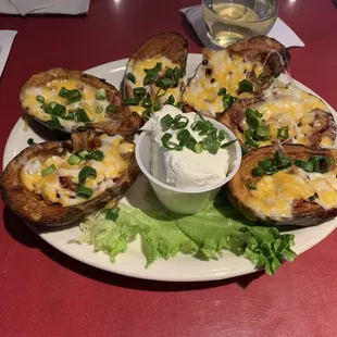 a plate of loaded baked potatoes