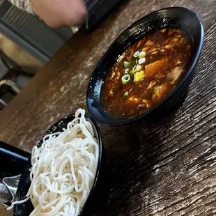 a bowl of noodles and a bowl of soup