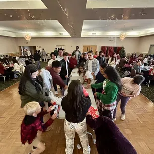 view of ballroom dance floor. Team Playing saran wrap ball game.
