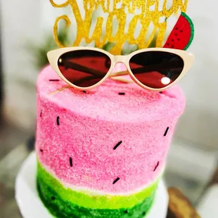 a watermelon cake with sunglasses on top