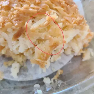 Curly hair in the middle of the coconut cake, just tossed in the trash... Not coming back!