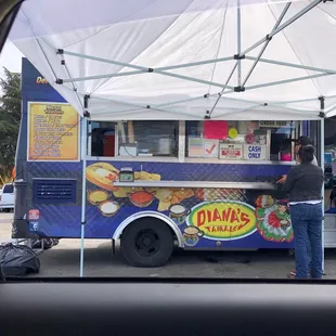 a woman ordering food from a food truck