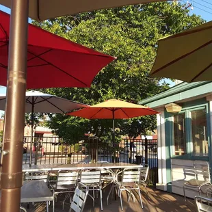 Nice breezy patio, colorful umbrellas.