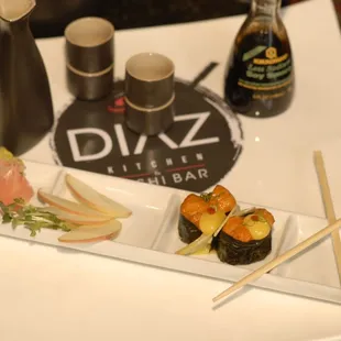 a plate of sushi and chopsticks