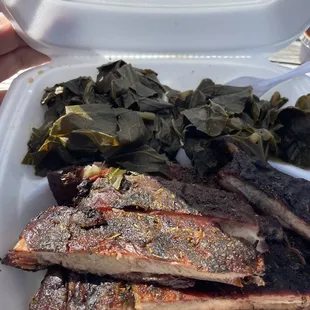 ribs and greens in a styrofoam container