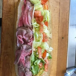 a sub sandwich on a cutting board