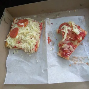 two slices of pizza in a box