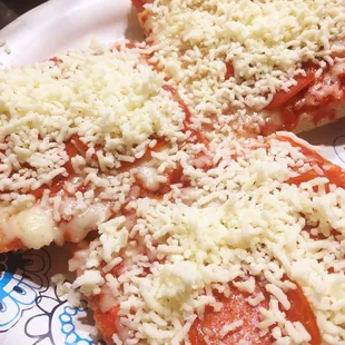 two slices of pizza on a paper plate