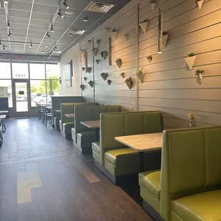 a view of a restaurant with booths and tables