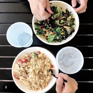 A rice bowl with chicken and fresh veggies and a custom salad