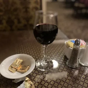 a glass of red wine and a plate of crackers
