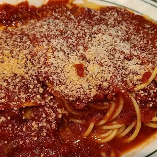 Combination plate: spaghetti, ravioli, and lasagna. Hard to tell because it&apos;s covered in sauce and cheese.