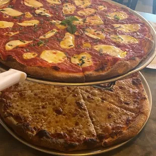 two pizzas on a table