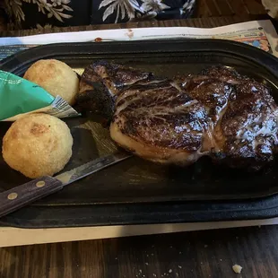 Medium rare rib eye with potato puffs