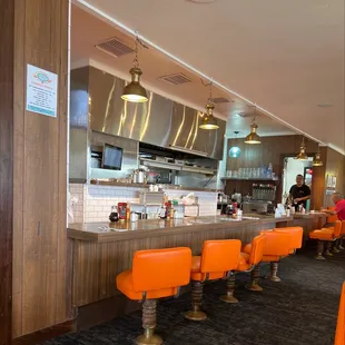 a restaurant with orange chairs