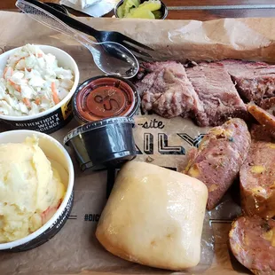 Brisket and cheese kielbasa with potato salad and slaw sides