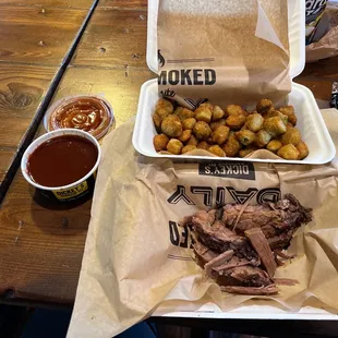 a tray of pulled pork and fried potatoes