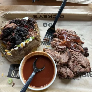 a pulled pork sandwich with a side of barbecue sauce