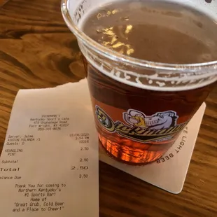 a cup of beer and a receipt