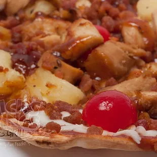 a pizza with a cherry on top