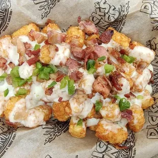 Our loaded tater tots are fried to perfection. Topped with our house queso and crispy bacon. We can't forget the fresh chives!
