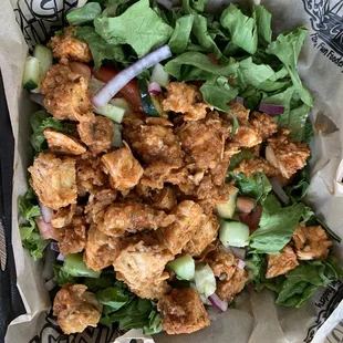 Garden salad with fried chicken tossed in hot garlic parm