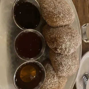 Beignets with chocolate sauce, raspberry sauce, and a honey drizzle ! Yum