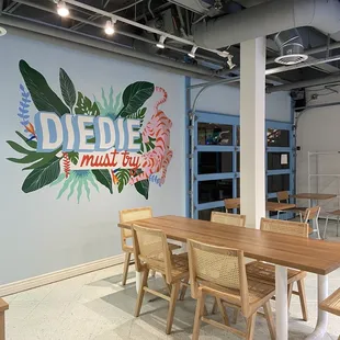 a restaurant with a mural on the wall