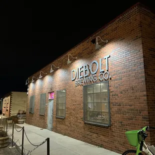 a bicycle parked in front of a brick building