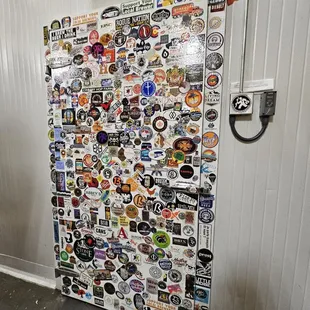 a refrigerator covered in stickers