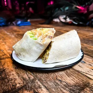 a burrito cut in half on a plate