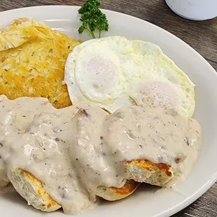 Biscuits and delicious gravy with eggs and hash browns.