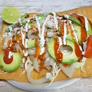 CHILINDRINAS -  flour chicharron - cabbagge - pork rinds - tomatoes - avocado -lime - hot sauce - powder cheese and sour cream