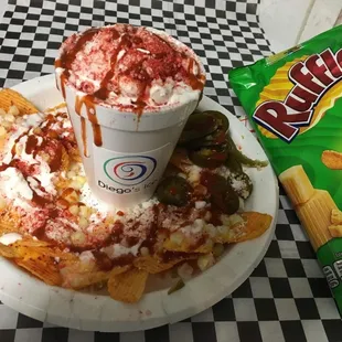 Elote Chorreado- corn in a cup with a base of chips with nacho cheese,corn