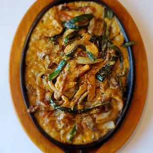 Fiery Fajitas, choice of chicken steak or mix..cooked with grill tomatoes, onion and poblanos topped with delicious spicy cheese sauce!!