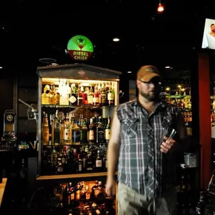 a man standing in front of a bar