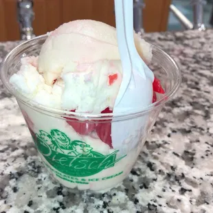 a cup of ice cream and strawberries