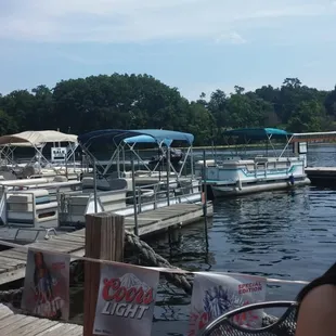 a woman sitting at a table on a dock