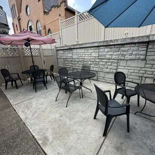 a patio with tables and chairs