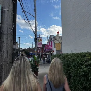 two women walking down a sidewalk